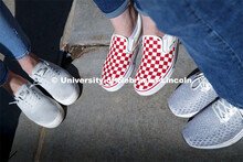 Harper Dining Center photo shoot. Students feet with fancy red and white checked Vans shoes. March 3