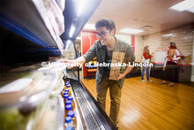 Selleck Dining Center photo shoot. Students select food out of the food cooler at Herbie's Market in