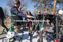 Carrick Detweiler shows Senator Deb Fischer, center, the progression of drones designed to start con