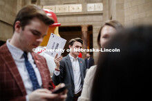 Drew Harrahill, a senior in biochemistry from Elkhorn, holds a sign to attract the attention of Sena