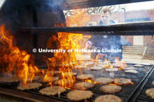 Dan Serdar, junior in Animal Science from Spring Grove, Illinois, flips hamburgers being grilled out