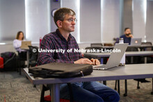 Chad Brassil, associate professor of biological sciences, listens as instructional designers from th