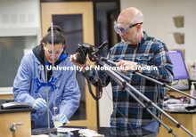 Jessica Periago, chemistry department lab manager, performs a Chem 110 lab as Kurt Wulser, chemistry