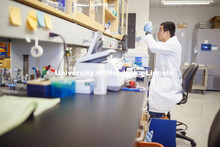 Qinnan Bob Yang extracts DNA from a fecal sample as works in Andrew Benson's Nebraska Food for Healt