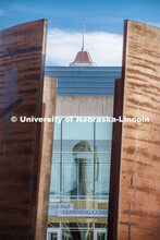 Mueller Bell Tower is reflected in the windows of Love Library, while being framed by the Greenpoint