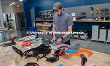 Max Wheeler, Shop Instructional Technician at Nebraska Innovation Studio, assembles face shields wit