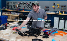 Max Wheeler, Shop Instructional Technician at Nebraska Innovation Studio, assembles face shields wit