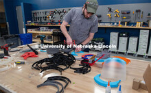 Max Wheeler, Shop Instructional Technician at Nebraska Innovation Studio, assembles face shields wit