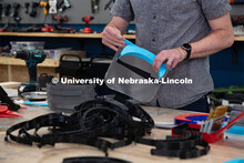 Max Wheeler, Shop Instructional Technician at Nebraska Innovation Studio, assembles face shields wit
