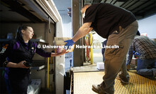 Ed Kearney, right, receives a package Monday morning from FedEx's Mary Chandler. Package delivery ha