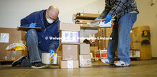 Pat Huberty checks in and sorts packages following a Monday morning FedEx delivery. Package delivery