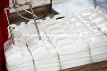 Jugs are filled two at a time with hand sanitizer is being made at Nebraska Innovation Campus thanks