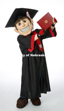 Herbie Husker proudly holds a diploma and is decked out in graduation attire for the Spring Commence