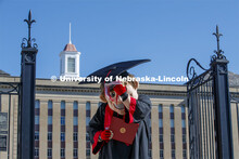 Herbie Husker turns his tassel in front of Love Library, and is decked out in graduation attire for 