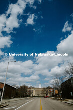 Fluffy clouds dot the sky above Love Library on City Campus looking north on 13th Street. April 14, 