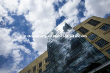 Clouds are reflected in the windows of Hawks Hall on City Campus. April 14, 2020. 