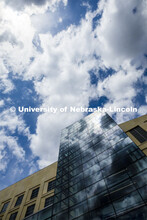 Clouds are reflected in the windows of Hawks Hall on City Campus. April 14, 2020. 