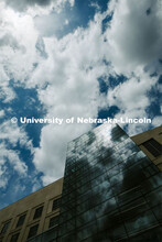 Clouds are reflected in the windows of Hawks Hall on City Campus. April 14, 2020. 
