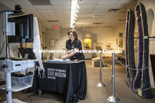 Annie Mumgaard, Virtual Learning Coordinator for the University Museum, uses a hammer to smash a geo
