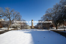 Spring trees covered in a blanket of snow surround the Mueller Bell Tower. An April snowstorm leaves