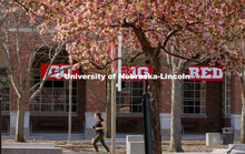 Alyssa Mahon, a junior in pre-health and nursing from Overland Park, KS, jogs past the blooming tree