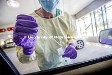 Dr. Scott Koepsell of UNMC prepares to test for COVID at a testing site in the 19th and Vine parking
