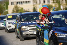 Elisa Peters and her sister, Miriam (in Husker hat) applaud the students along with their grandparen