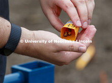 James Schnable pours corn kernels into his hand for the next row of planting. East Campus ag fields.