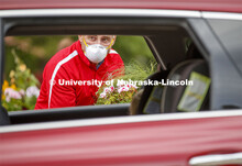 Stacy Adams, Associate Professor of Practice for Agronomy and Horticulture, waits for a driver to un