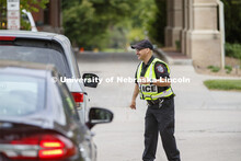 UNL Police direct the huge traffic flow for people coming for the free flat of flowers left from the