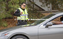 UNL Police Officer Anderson Delgado directs the huge traffic flow for people coming for the free fla