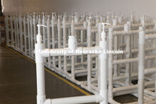 Finished Hand Sanitizer Stations line the hallways waiting to have signage added before they are shi