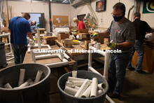 Housing Facilities staff Cole Wilson (in blue) and Blake Savidge (in gray) assemble the PVC to make 
