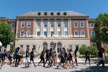 Protestors walk past the south entrance of the Nebraska Union during their march to the Nebraska Sta