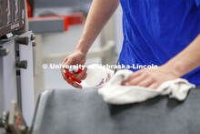 A student disinfects a weight station following his workout. First day of Campus Recreation re-openi