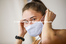 Olivia Boldt, senior from Madison, South Dakota, puts on her mask before going to work out. First da