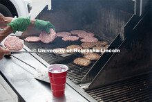 A grill full of pork burgers gets cooked up for the Lincoln City Mission. The pork, donated by pig f