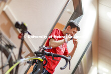 Edwin Mendez-Rodriguez puts on his mask as he leaves a University Suites Residence Hall room. Photo 