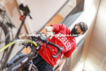 Edwin Mendez-Rodriguez puts on his mask as he leaves a University Suites Residence Hall room. Photo 