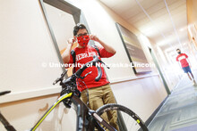 PJ Miguelino puts on his mask as he leaves a University Suites Residence Hall room. Photo shoot of s