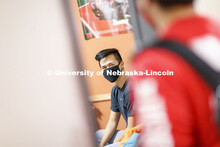 Photo shoot of students wearing masks and practicing social distancing in a University Suites Reside