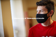 Edwin Mendez-Rodriguez in a University Suites Residence Hall room. Photo shoot of students wearing m