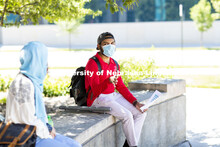 Aldi Airori talks with Sonoor Majid. Both are wearing masks and practicing social distancing. Photo 