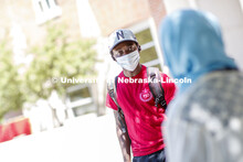 Mark Iradukunda wears a mask while he talks with Sonoor Majid. Photo shoot of students wearing masks