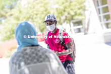 Mark Iradukunda wears a mask while he talks with Sonoor Majid. Photo shoot of students wearing masks