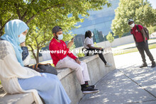 Aldi Airori checks his phone while wearing a mask and practicing social distancing outdoors. Photo s