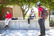 Shemsa Ndahiro talks with Mark Iradukunda as Aldi Airori, left, checks his phone. Photo shoot of stu