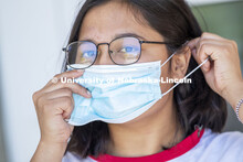 Sandhya Karki demonstrates how to put on a mask. Photo shoot of students wearing masks and practicin