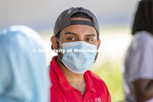 Aldi Airori talks with Sonoor Majid. Photo shoot of students wearing masks and practicing social dis