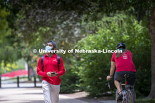 Aldi Airori walks across campus wearing his mask. Photo shoot of students wearing masks and practici